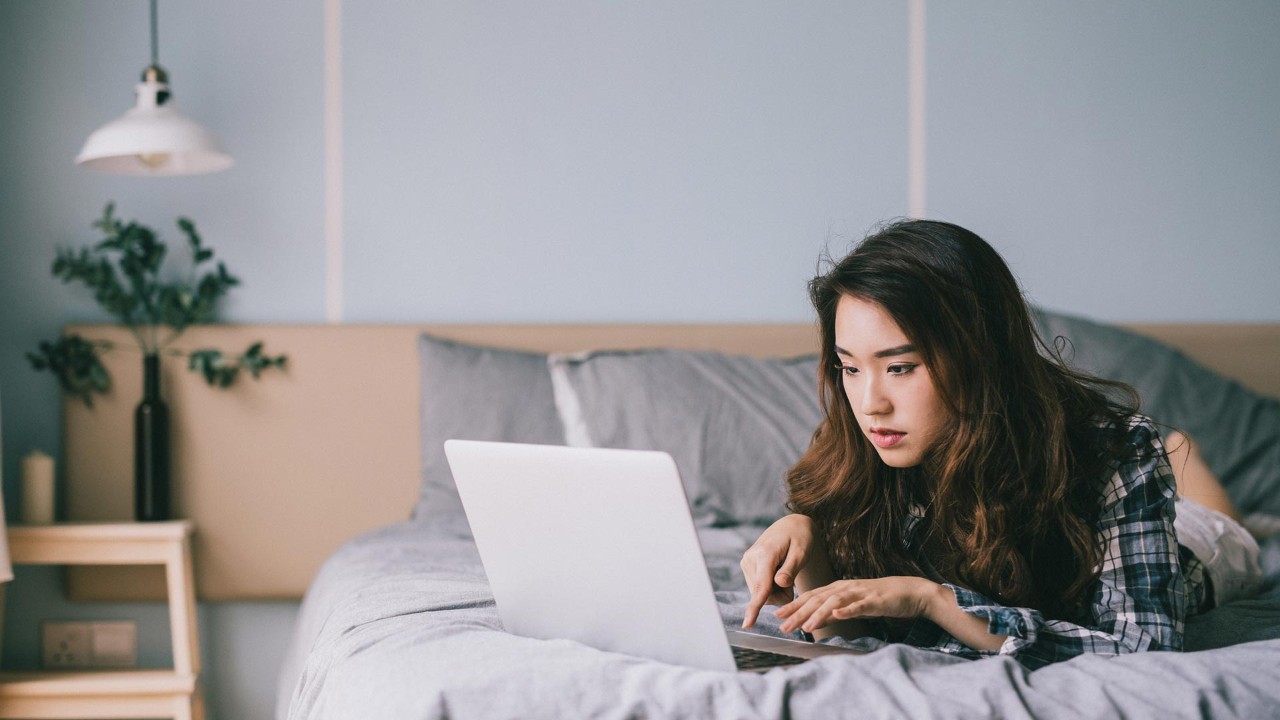 Girl watching computer in bed; the image used for understanding interest